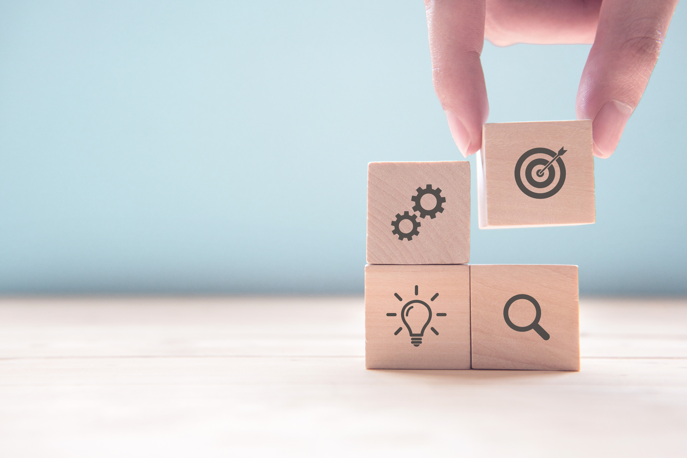 Businessman hand arranging wood block with icon business strategy and Action plan, copy space.